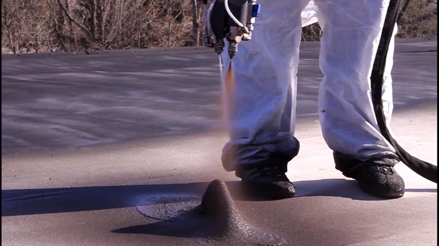 Applicator spraying a seal coating